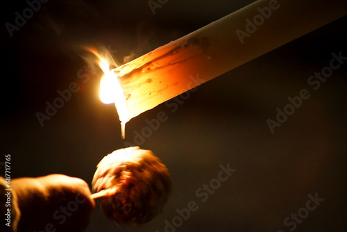 Φωτογραφία A child collecting wax with his ball during semana santa