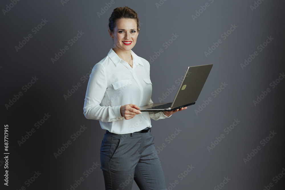 happy trendy female employee isolated on gray background happy trendy female employee isolated on gray background
