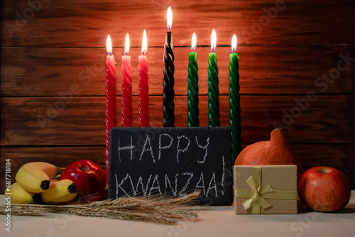 Kwanzaa African American holiday. Seven candles on wooden background. photo