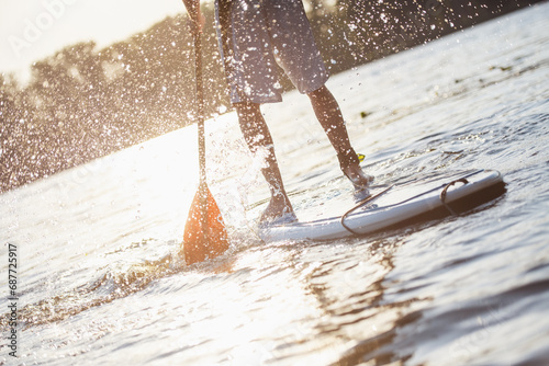 Man standup paddleboarding photo
