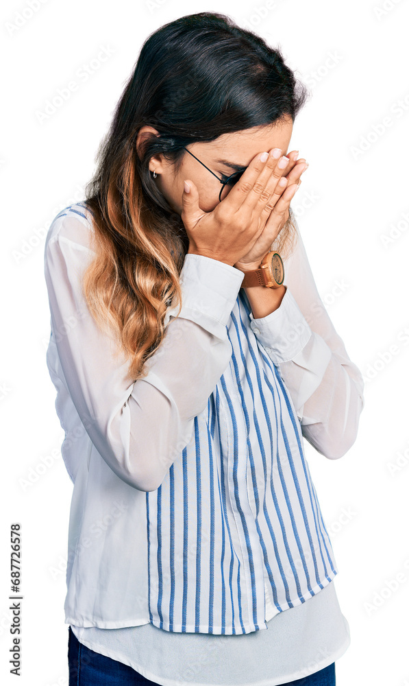Beautiful hispanic woman wearing casual striped shirt with sad expression covering face with hands while crying. depression concept. Beautiful hispanic woman wearing casual striped shirt with sad expression covering face with hands while crying. depression concept.