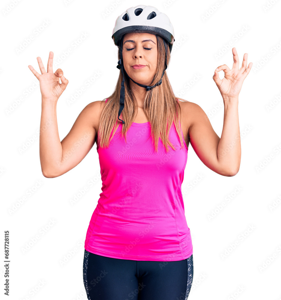 Young beautiful woman wearing bike helmet relax and smiling with eyes closed doing meditation gesture with fingers. yoga concept. Young beautiful woman wearing bike helmet relax and smiling with eyes closed doing meditation gesture with fingers. yoga concept.