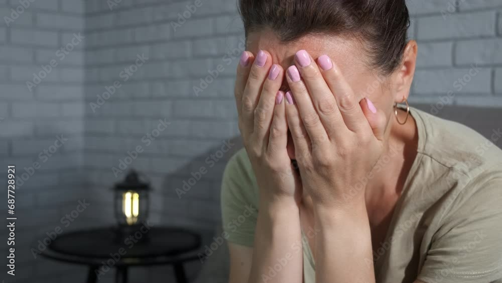 Woman with grief on sofa. A view of upset woman think about her problems indoor.