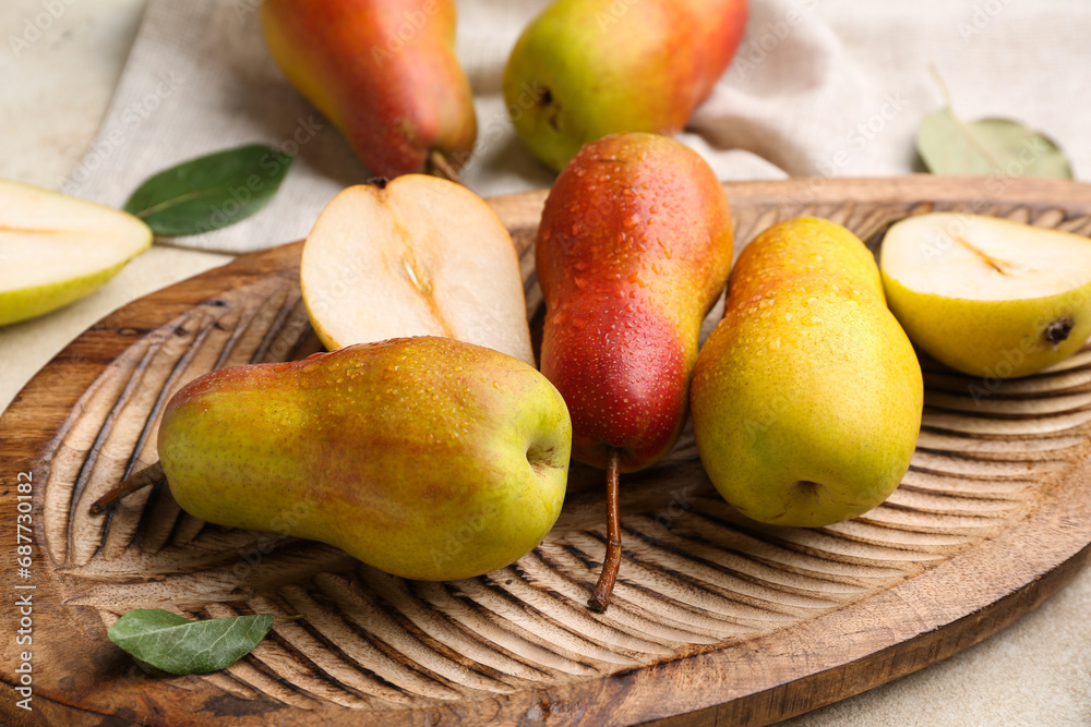 Wooden board with ripe pears on white background Wooden board with ripe pears on white background