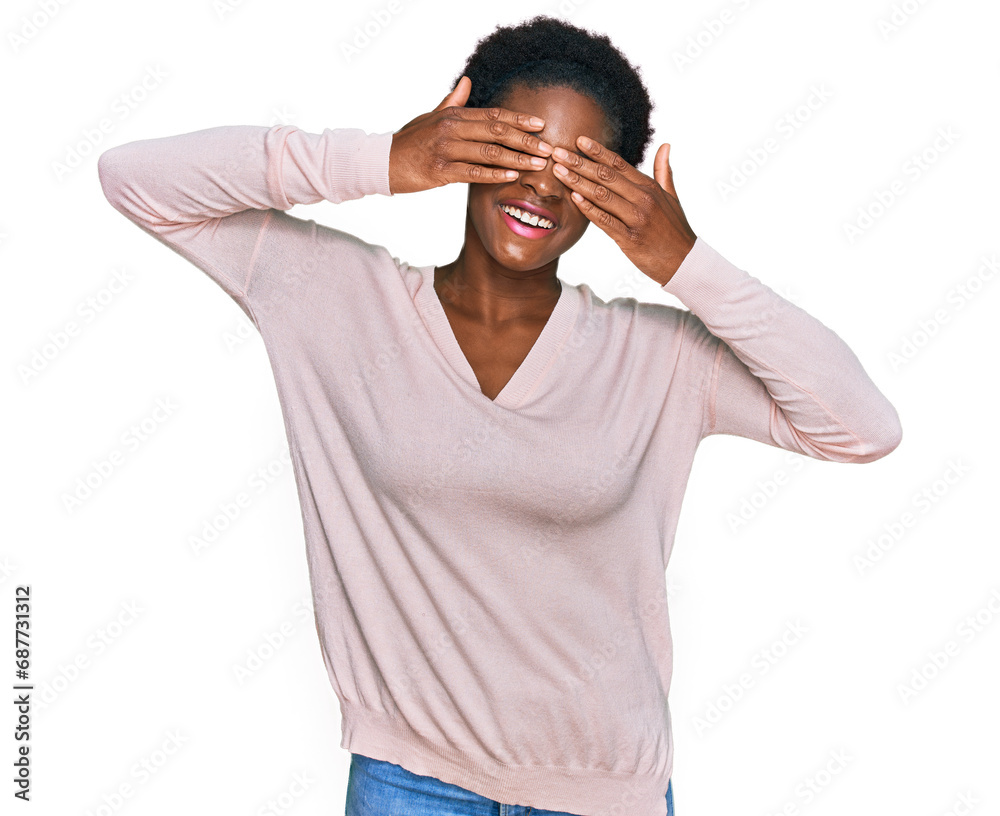 Young african american girl wearing casual clothes covering eyes with hands smiling cheerful and funny. blind concept. Young african american girl wearing casual clothes covering eyes with hands smiling cheerful and funny. blind concept.