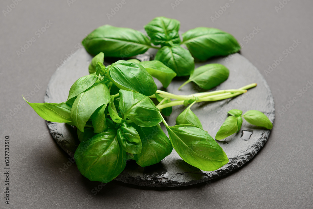 Board with fresh basil on black background Board with fresh basil on black background