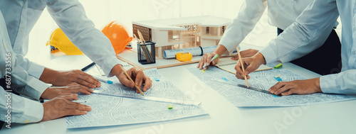 Worker, architect and engineer work on real estate construction project oratory planning with cartography and cadastral map of urban town area to guide to construction developer business plan of city photo