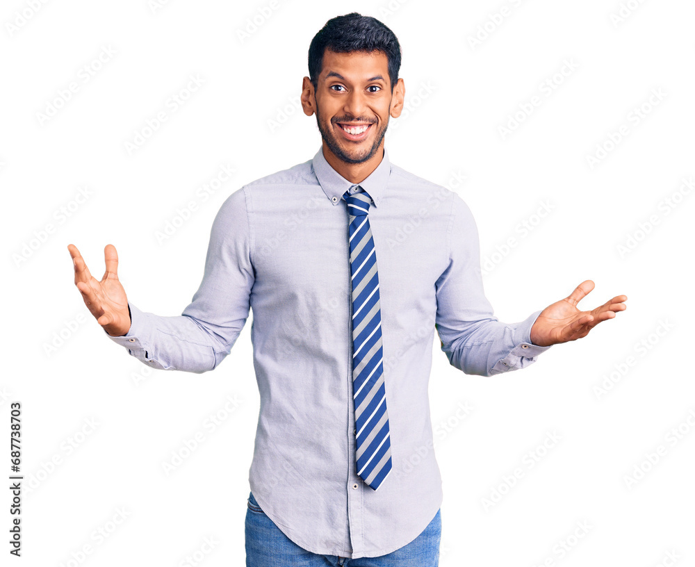 Young latin man wearing business clothes celebrating victory with happy smile and winner expression with raised hands Young latin man wearing business clothes celebrating victory with happy smile and winner expression with raised hands