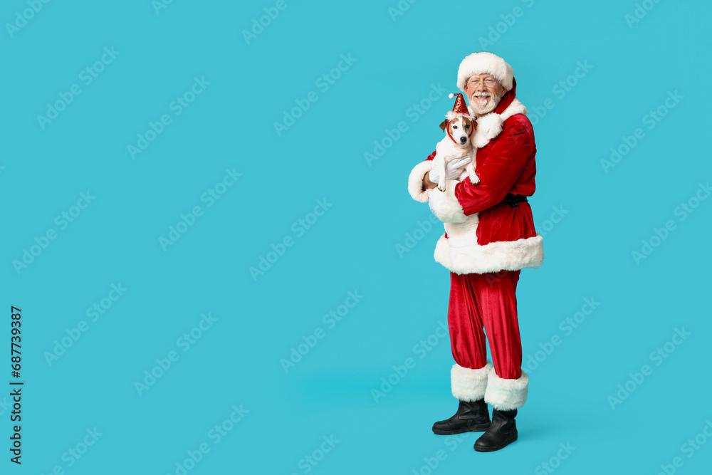 Happy Santa Claus with cute Jack Russell Terrier dog on blue background