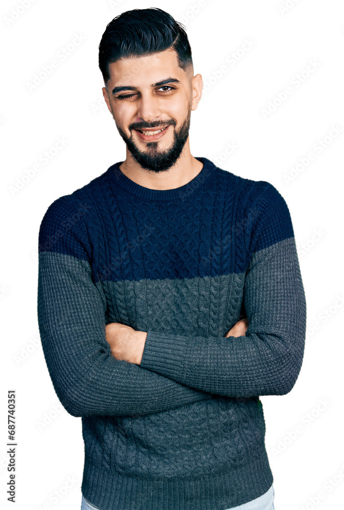 Young arab man with beard with arms crossed gesture winking looking at the camera with sexy expression, cheerful and happy face. Young arab man with beard with arms crossed gesture winking looking at the camera with sexy expression, cheerful and happy face.
