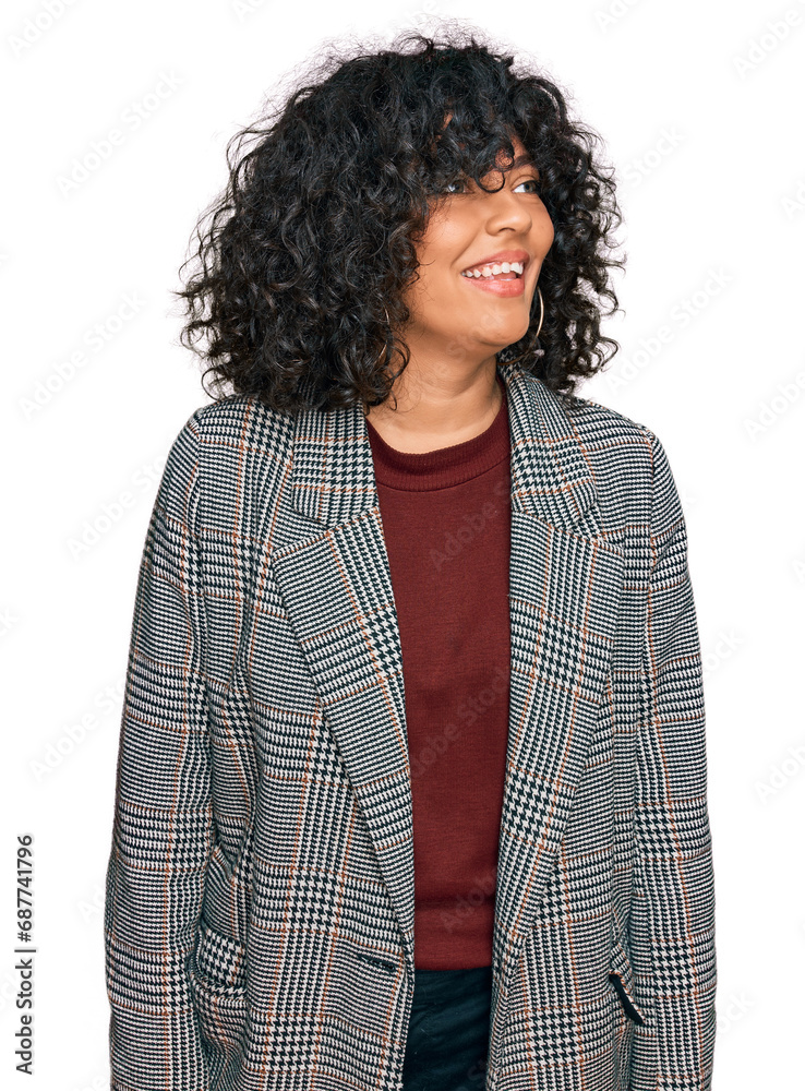 Young hispanic woman wearing business clothes looking away to side with smile on face, natural expression. laughing confident. Young hispanic woman wearing business clothes looking away to side with smile on face, natural expression. laughing confident.