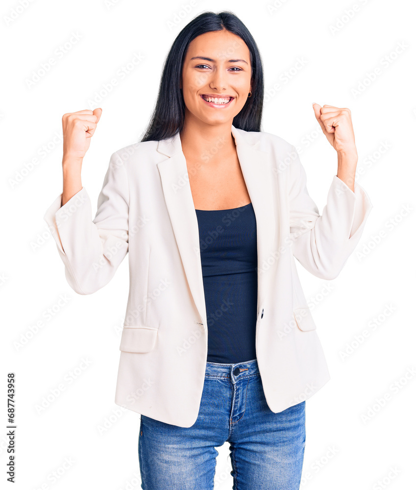 Young beautiful latin girl wearing business clothes screaming proud, celebrating victory and success very excited with raised arms Young beautiful latin girl wearing business clothes screaming proud, celebrating victory and success very excited with raised arms