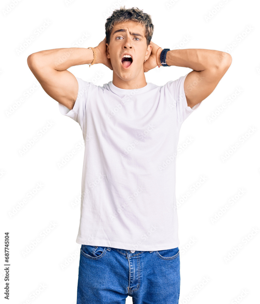 Young handsome man wearing casual white tshirt crazy and scared with hands on head, afraid and surprised of shock with open mouth