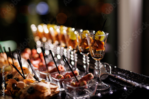 Tableau sur toile Variety of appetizers and snacks in small glasses at the event