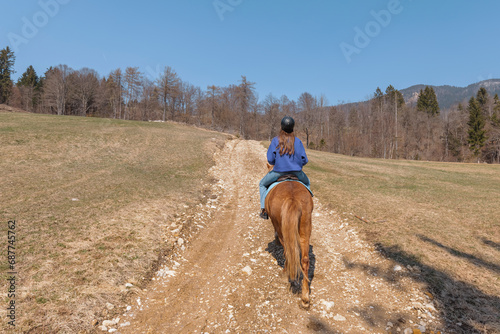 Young woman riding Icelandic horse in nature at spring. © 24K-Production