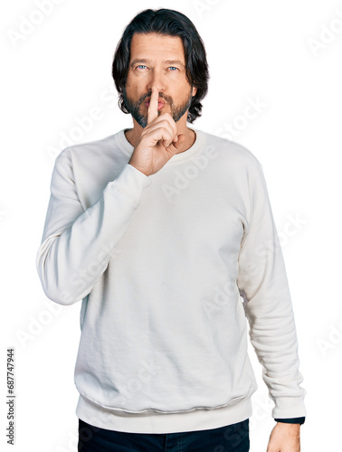 Middle age caucasian man wearing casual clothes asking to be quiet with finger on lips. silence and secret concept.