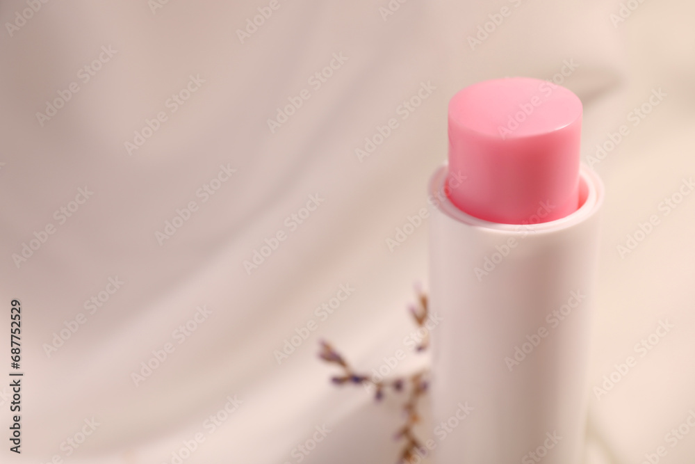 Lip balm against blurred background, closeup. Space for text - obrazy, fototapety, plakaty 