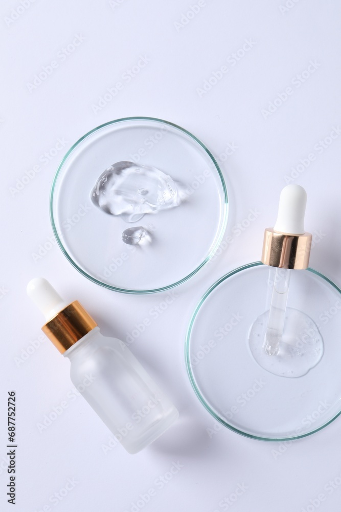 Petri dishes with samples of cosmetic serums, pipette and bottle on white background, flat lay Petri dishes with samples of cosmetic serums, pipette and bottle on white background, flat lay