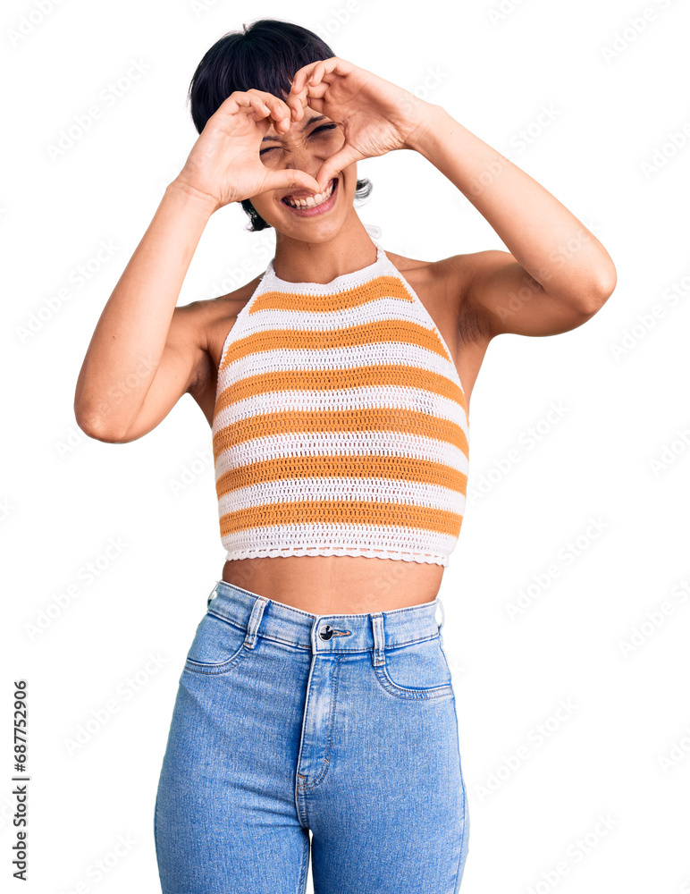 Young brunette woman with short hair wearing casual clothes doing heart shape with hand and fingers smiling looking through sign Young brunette woman with short hair wearing casual clothes doing heart shape with hand and fingers smiling looking through sign
