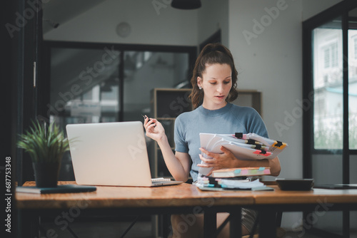 Business woman using business paper for doing math finance on office desk, tax, report, accounting, statistics, and analytical research concept