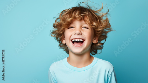 Portrait of a happy young boy on a solid background photo