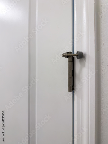 This door stopper mounts on the hinge pin of the door