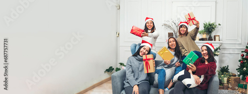 Banner Group of Asian Woman party exchange christmas gift box xmas tree surprise present. Women holding gift box sitting living room celebrate christmas xmas holiday winter festival with copy space photo