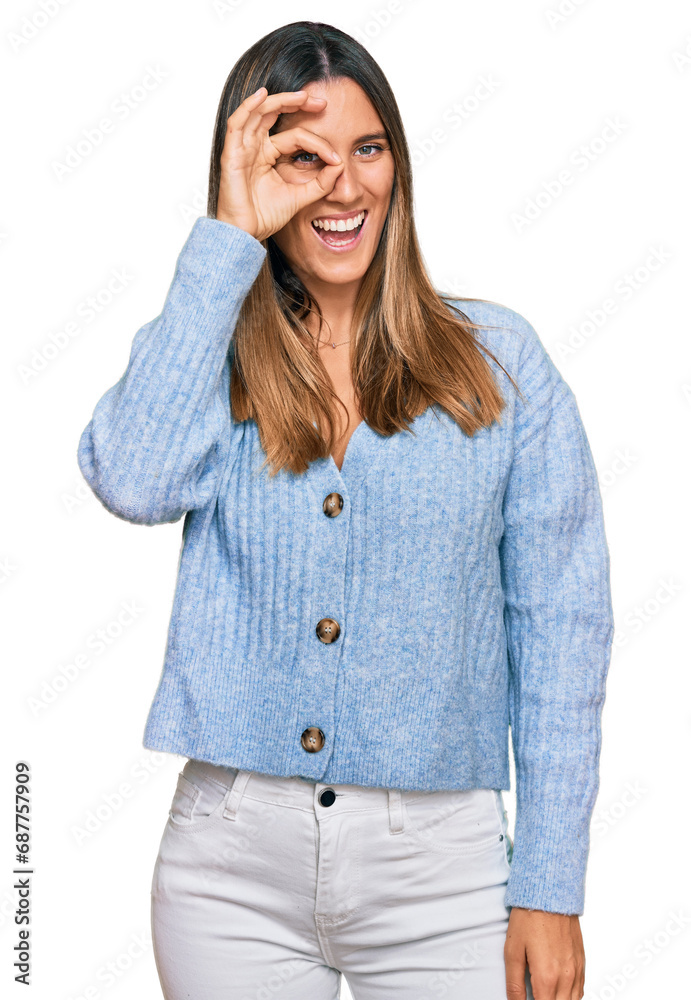 Young woman wearing casual clothes doing ok gesture with hand smiling, eye looking through fingers with happy face. Young woman wearing casual clothes doing ok gesture with hand smiling, eye looking through fingers with happy face.