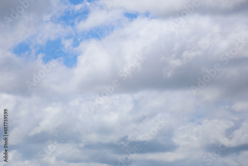 Blue sky with white clouds in the daytime background.