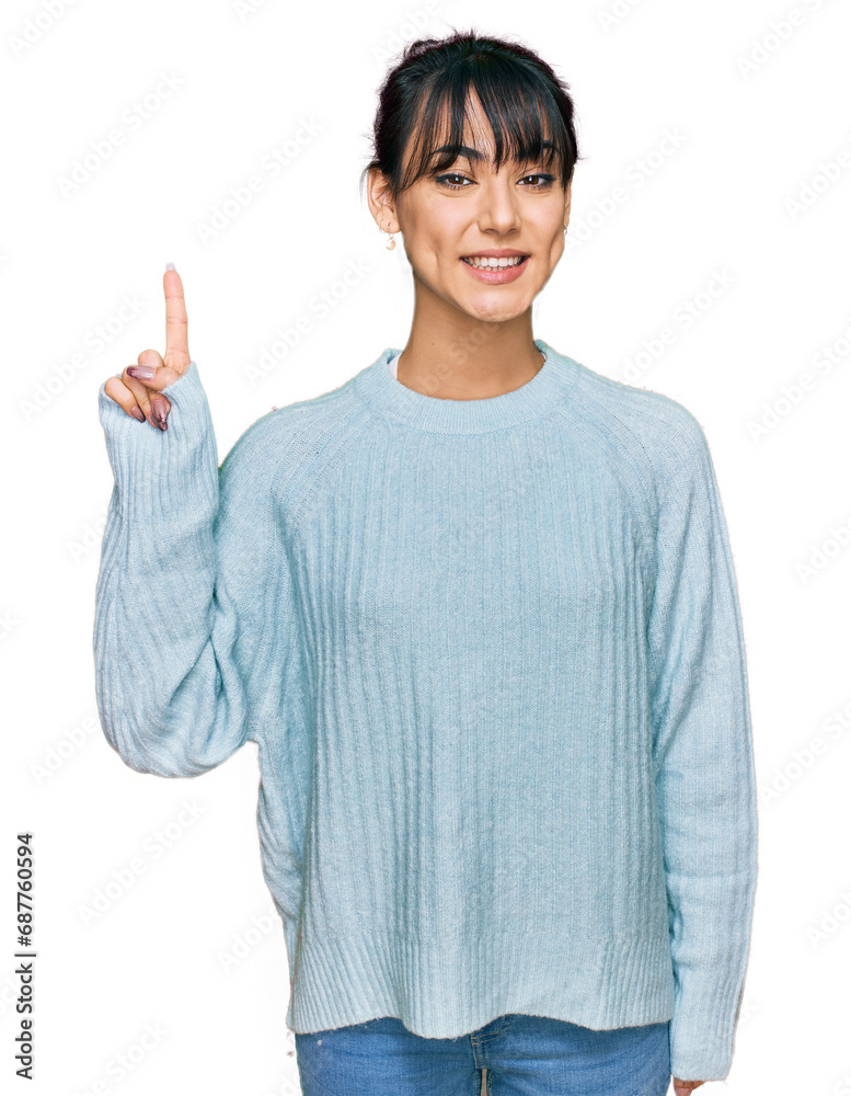 Young hispanic woman wearing casual clothes showing and pointing up with finger number one while smiling confident and happy. Young hispanic woman wearing casual clothes showing and pointing up with finger number one while smiling confident and happy.