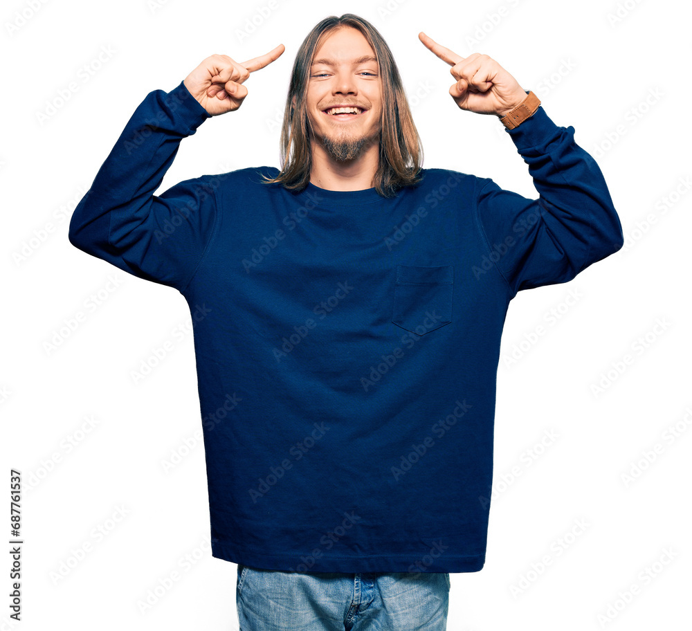 Handsome caucasian man with long hair wearing casual winter sweater smiling pointing to head with both hands finger, great idea or thought, good memory Handsome caucasian man with long hair wearing casual winter sweater smiling pointing to head with both hands finger, great idea or thought, good memory