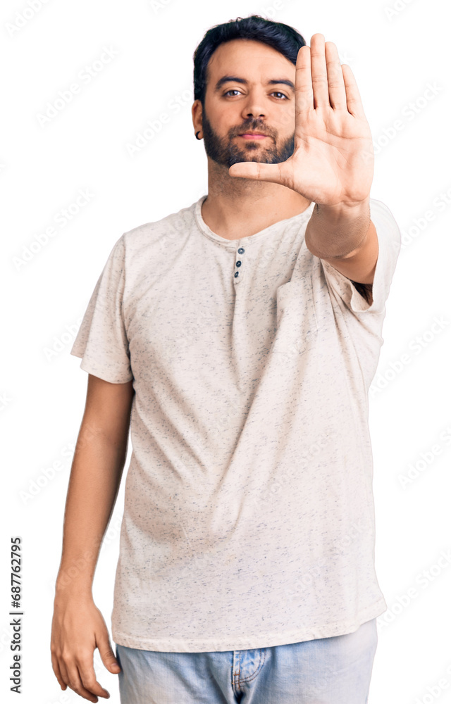 Young hispanic man wearing casual clothes doing stop sing with palm of the hand. warning expression with negative and serious gesture on the face. Young hispanic man wearing casual clothes doing stop sing with palm of the hand. warning expression with negative and serious gesture on the face.