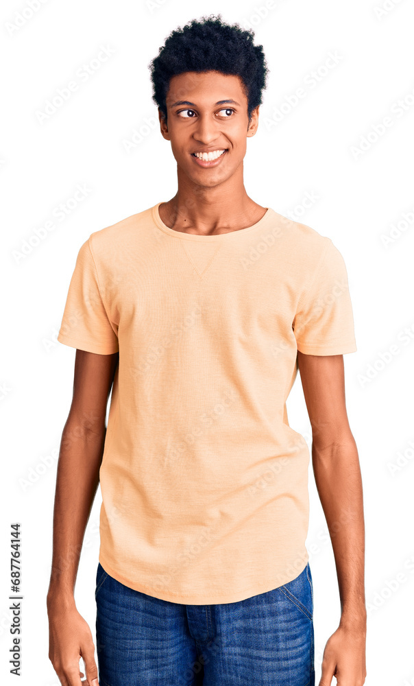 Young african american man wearing casual clothes looking away to side with smile on face, natural expression. laughing confident. Young african american man wearing casual clothes looking away to side with smile on face, natural expression. laughing confident.