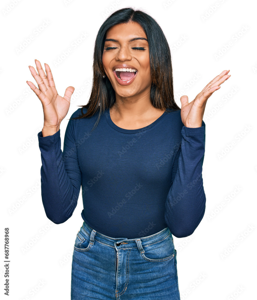 Young latin transsexual transgender woman wearing casual clothes celebrating mad and crazy for success with arms raised and closed eyes screaming excited. winner concept Young latin transsexual transgender woman wearing casual clothes celebrating mad and crazy for success with arms raised and closed eyes screaming excited. winner concept