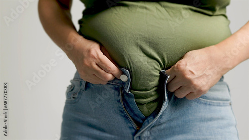 Foto Fat  woman zipping up trousers, excess belly fat, unhealthy lifestyle