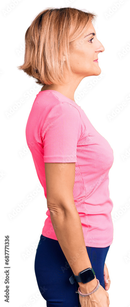 Young blonde woman wearing sportswear looking to side, relax profile pose with natural face and confident smile. Young blonde woman wearing sportswear looking to side, relax profile pose with natural face and confident smile.