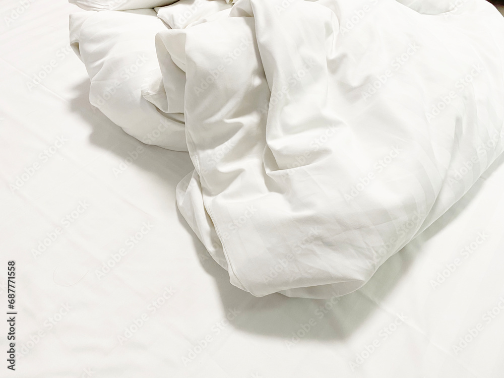 Obraz premium after waking up in the​ morning. The crinkle blanket on the bed in the hotel with the sun​light​ on​ the​ blanket