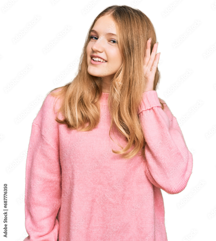 Beautiful young caucasian girl wearing casual winter sweater smiling with hand over ear listening an hearing to rumor or gossip. deafness concept. Beautiful young caucasian girl wearing casual winter sweater smiling with hand over ear listening an hearing to rumor or gossip. deafness concept.
