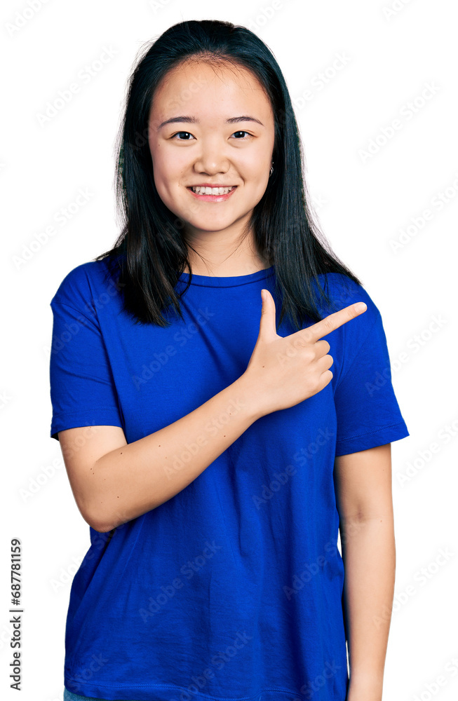 Young chinese woman wearing casual blue t shirt smiling cheerful pointing with hand and finger up to the side Young chinese woman wearing casual blue t shirt smiling cheerful pointing with hand and finger up to the side