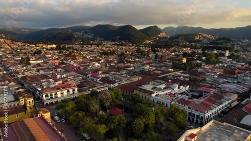 Sunset casts a golden spell as we soar above San Cristobal's lively townsquare—a vibrant tapestry of culture. photo
