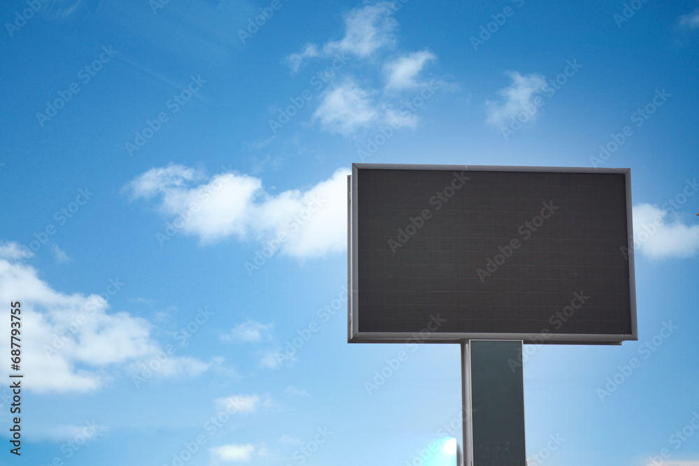 Outdoor billboard on blue sky background with black background mock up. Outdoor billboard on blue sky background with black background mock up.