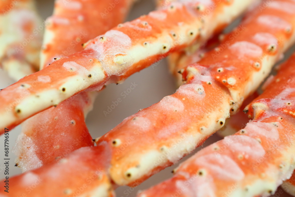frosted Alaska king crab legs close up photo on white table background frosted Alaska king crab legs close up photo on white table background