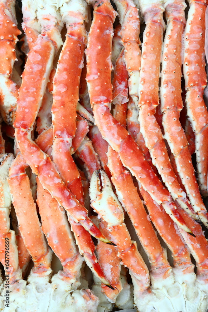 frosted Alaska king crab legs close up photo on white table background frosted Alaska king crab legs close up photo on white table background