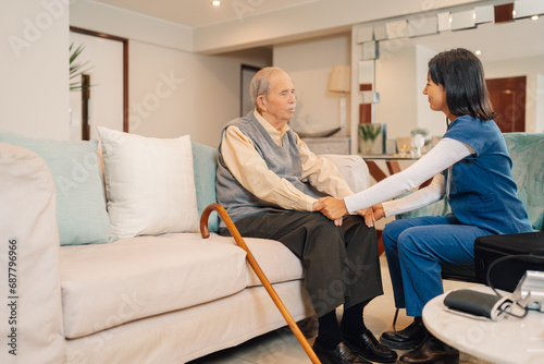 Home nurse talking to an old man during a visit