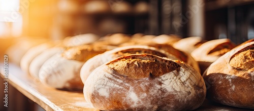 Close-ups of round, golden-crusted sourdough bread on bakery shelves in a shop context, alongside delicious pastries.