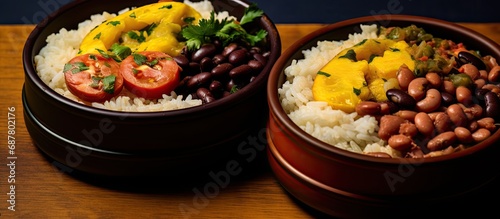 Brazilian-style lunchboxes consisting of rice and beans as the foundation.