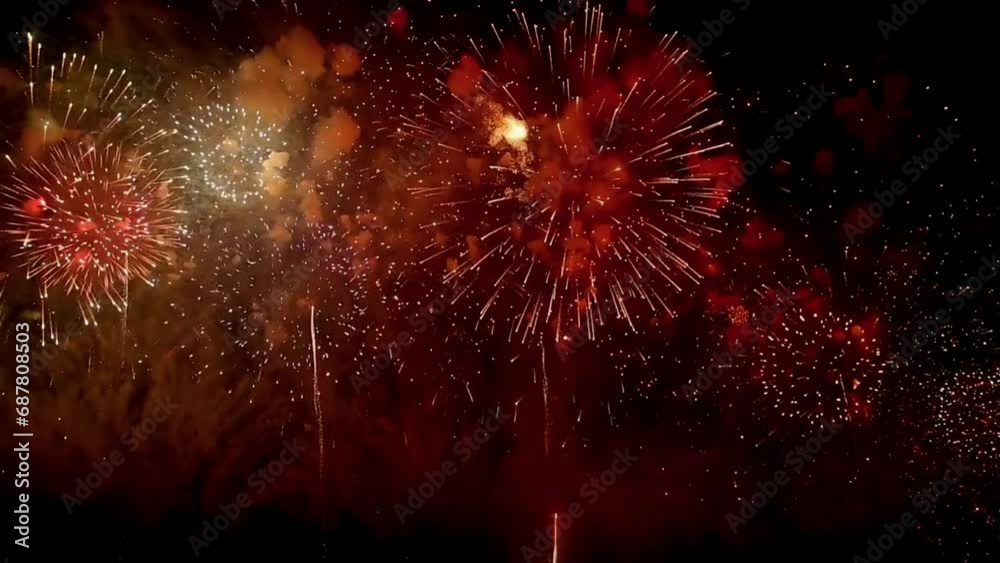 Fireworks Background - Celebrating Festival's 4K New year's eve fireworks celebration loop seamless of real fireworks background. abstract Multicolor golden shining glowing fireworks