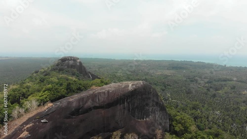 Flying backwards at batu beginde viewpoint  at Belitung Indonesia, aerial photo