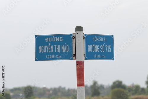 Fototapeta Naklejka Na Ścianę i Meble -  This is a Vietnamese street sign. It shows the street type at the type (Duong is a Street or Road) then the street name in big writing and the small writing at the bottom is the ward. 