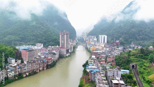 panoramic aerial of Yunnan city, Yanjin county from river, apartment buildings and chinese homes photo